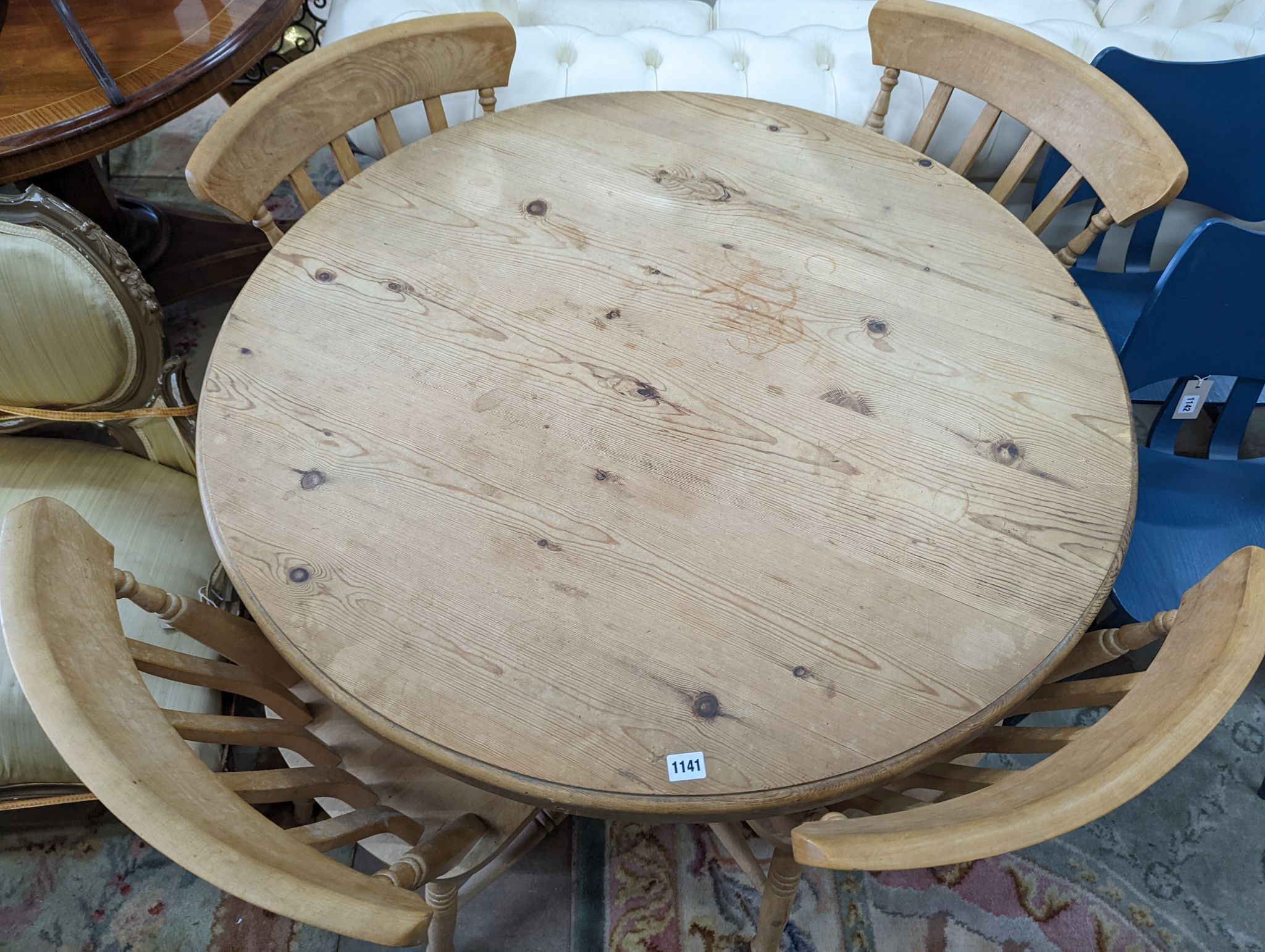 A Victorian style circular pine breakfast table, diameter 105cm, height 74cm, together with four Victorian style beech lathe back kitchen chairs